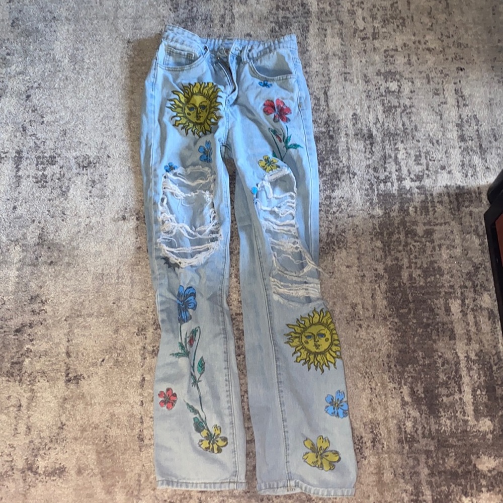 Light blue jeans with sun designs and flowers